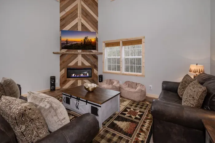 Cozy up in comfort with a 65" Roku Smart TV, electric fireplace, and plenty of seating for movie nights or game day fun.