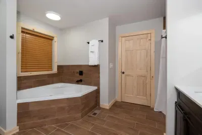 Enjoy added privacy with a dedicated foyer behind the wood door that connects your spa-inspired bathroom to the master king retreat. ✨