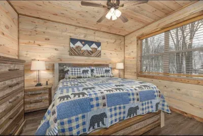 Sleep like royalty in this cozy master king retreat!  This bedroom features a modern antique-style IFD king bedroom set and plush linens for the dreamiest mountain sleep imaginable.