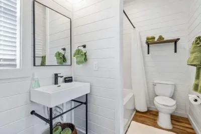 This ensuite bathroom to the second king bedroom offers a bright, modern space with a combination tub/shower and thoughtful touches for a comfortable stay.