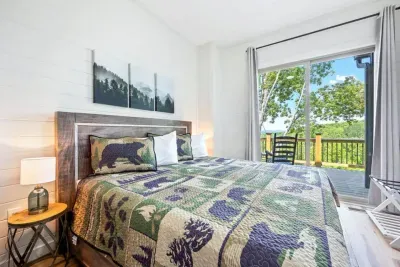 This second master king bedroom offers plush comfort, peaceful natural light, and direct deck views, complete with its own ensuite bathroom for added privacy and convenience.