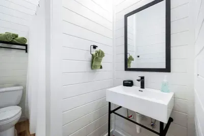 Modern basement bathroom.  Fresh, bright, and stylish—this bathroom features sleek black fixtures and a spa-like, minimalist design.