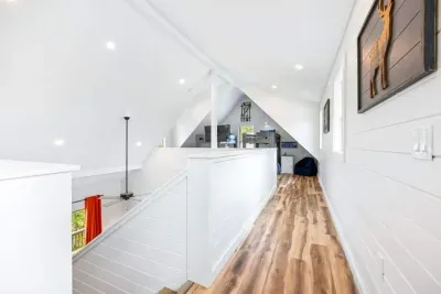 Third-floor loft walkway.  This bright, open hallway connects the hangout zone to the bunk area, creating the perfect layout for kids, teens, and late-night movie marathons.