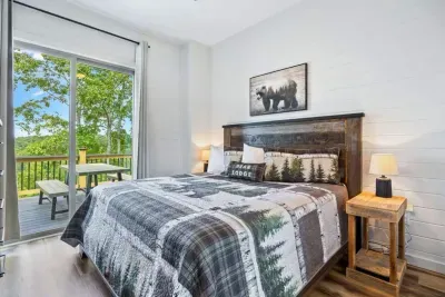 Located on the main level, the master king bedroom features warm cabin-inspired décor, comfortable luxury bedding, and a peaceful setting, providing comfort and convenience throughout your stay.