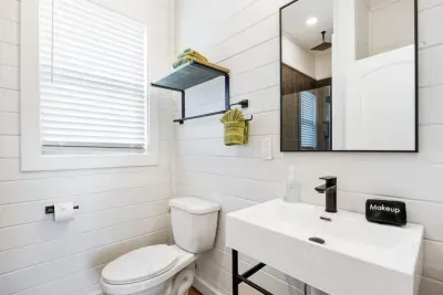 Modern master bathroom design.  This bright master bath now includes a black storage cabinet between the toilet and sink (not shown)—perfect for keeping toiletries and bathroom bags organized.
