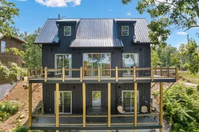 Double the decks, double the views.  This beautiful backside view highlights the cabin’s multiple decks, oversized sliding glass doors, and peaceful setting — perfect for soaking in the mountain air from every level.