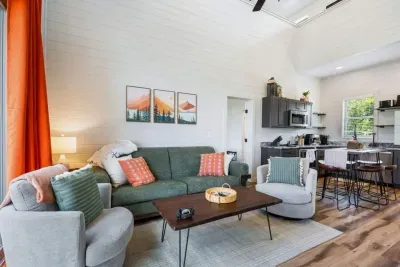 This cozy, spacious family room offers soft seating and an open layout that flows into the kitchen, creating an ideal space for gathering, relaxing, and enjoying time together.