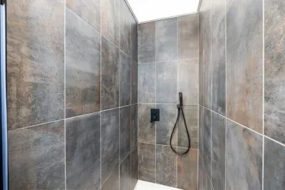 Retreat to the master suite’s spa-inspired bathroom.  A fully tiled walk-in shower with a luxurious rain shower head (just out of view) for the ultimate unwind.