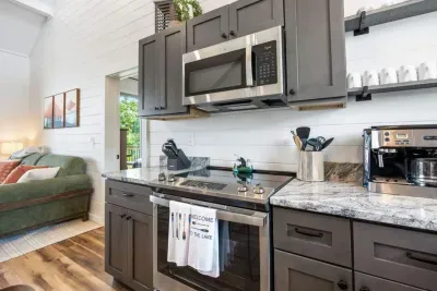 Enjoy a fully functional kitchen equipped with an electric stovetop, oven, and microwave, providing everything you need for quick meals or full dinners.