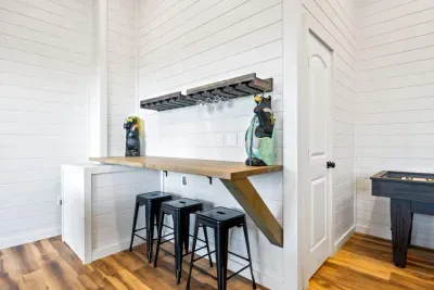 Bar by night, office by day.  This built-in bar doubles as a work-from-anywhere station (setup not shown), featuring a 32" LCD monitor, docking station, and keyboard/mouse for easy plug-and-play.