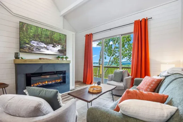 Welcome to your lake escape at Whatever Floats Your Boat!  Step into a bright, cozy living space where panoramic views, a warm fire, and calm, airy comfort set the tone for an unforgettable stay.