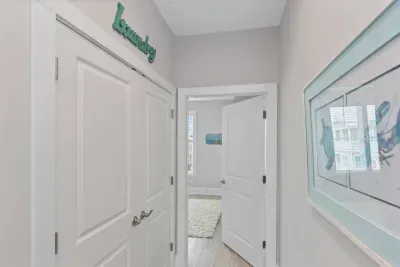 Laundry day made easy!  This hallway features a full-size washer & dryer behind closed doors and direct access to the master bedroom.