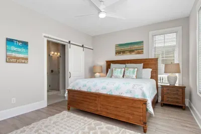 Wake up to pool views & coastal breezes!  This master suite offers a king bed, ensuite bath, and nightstands with built-in USB chargers for your convenience.