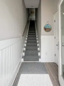 Fresh updates!  New rugs and elegant beadboard accents give our stairwells and hallways a stylish, cozy feel for your beach getaway.