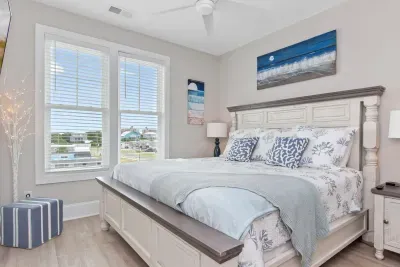 Coastal dreams await!  This guest king bedroom features an elegant IFD Stone bedroom set and a soothing moonlit beach theme.