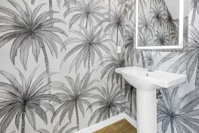 Chic tropical powder room with bold palm wallpaper and modern finishes
