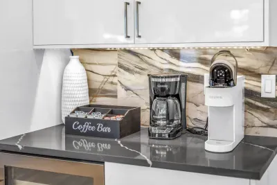 Modern coffee bar with Keurig, drip maker, and elegant marble backsplash