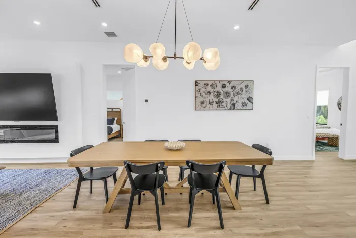 Bright modern dining space with seating for 8 and designer lighting