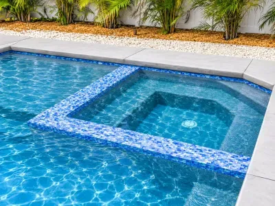 Resort-style pool and spa with tropical landscaping