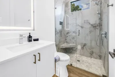Spa-like bathroom with marble-style walk-in glass shower