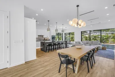 Bright open-plan living with designer kitchen, dining, and garden views