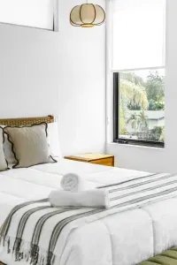 Bright, serene bedroom with natural light and a polished boutique feel
