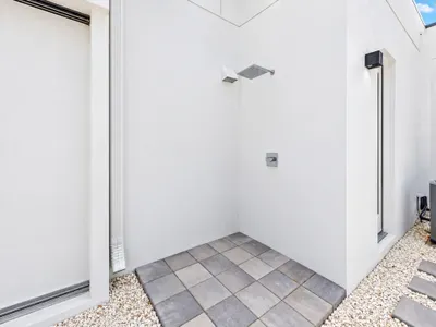 Modern open-air outdoor shower with a clean, resort-style design