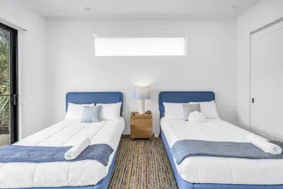 Bright double-bedroom with two cozy beds and clean coastal style