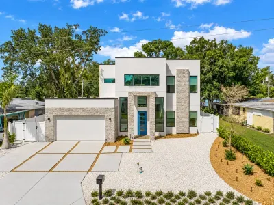 Stylish modern home with sleek design, spacious drive, and standout curb appeal