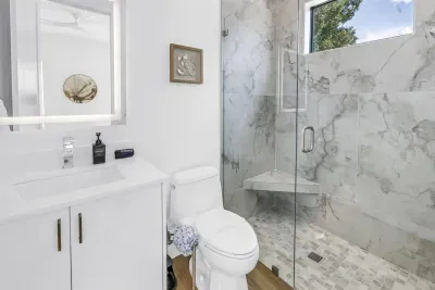 Spa-like bathroom with marble shower and bright modern finishes
