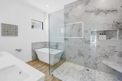 Spa-style bathroom with soaking tub & spacious glass walk-in shower