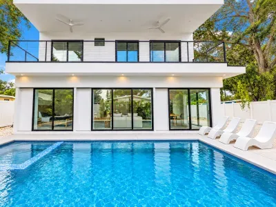 Modern home with private pool, balcony, and bright indoor-outdoor living