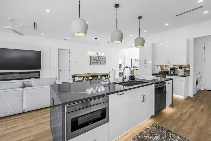 Bright open-concept kitchen with large island, dining space, and modern finishes