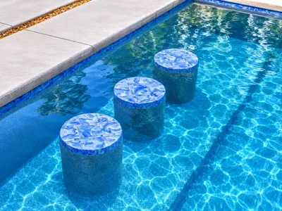 Resort-style pool with in-water stools for relaxing sunny afternoons