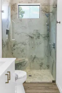 Spa-style marble shower with natural light and sleek modern finishes