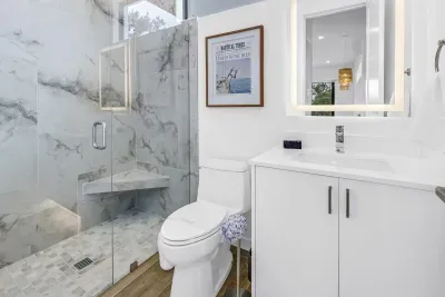 Spa-like bathroom with marble-style walk-in shower and modern vanity