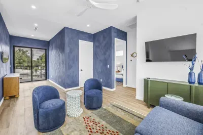 Stylish blue lounge with balcony access and modern seating