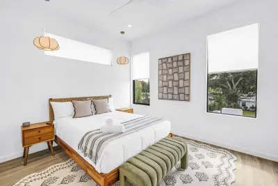 Bright, serene bedroom with leafy views and stylish modern touches