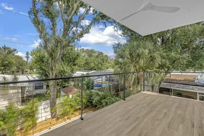 Spacious covered balcony with treetop views and a modern, private feel