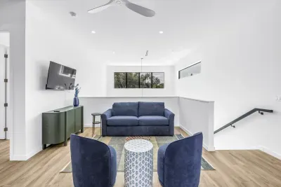Bright modern lounge with cozy seating, TV, and airy loft-style design