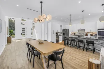 Bright open-concept kitchen and dining with waterfall island seating