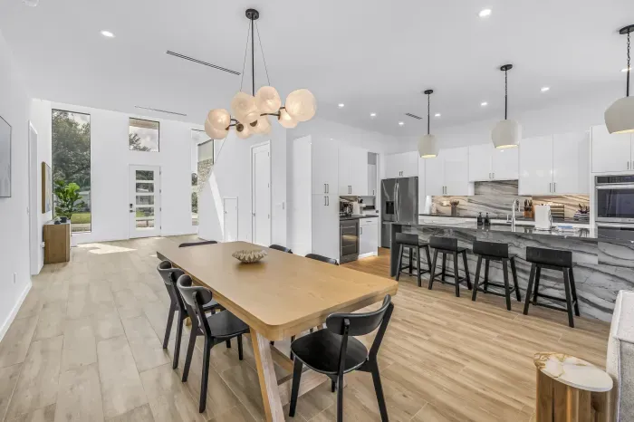 Bright open-concept kitchen and dining with waterfall island seating