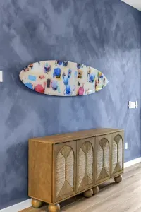 Coastal-chic entryway with bold blue wall and surf-inspired art