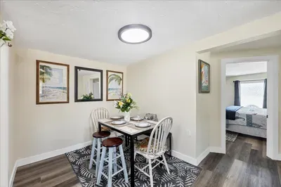 Cozy dining nook for four with coastal touches and bright, modern lighting