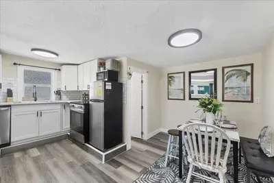 Bright kitchen with subway tile, stainless accents & cozy dining nook