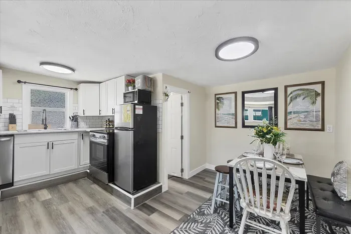 Bright kitchen with subway tile, stainless accents & cozy dining nook