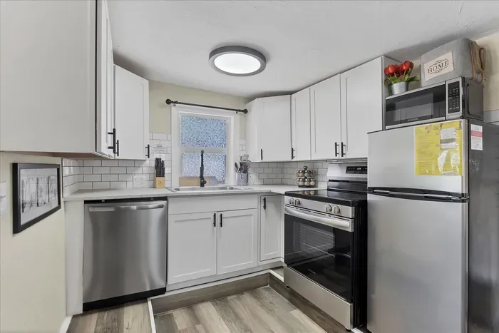 Bright modern kitchen with stainless appliances & subway tile