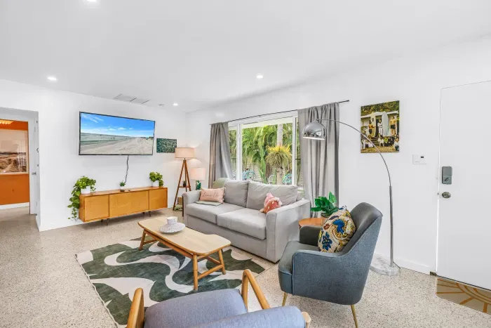 Bright, stylish living room with garden views and cozy modern seating