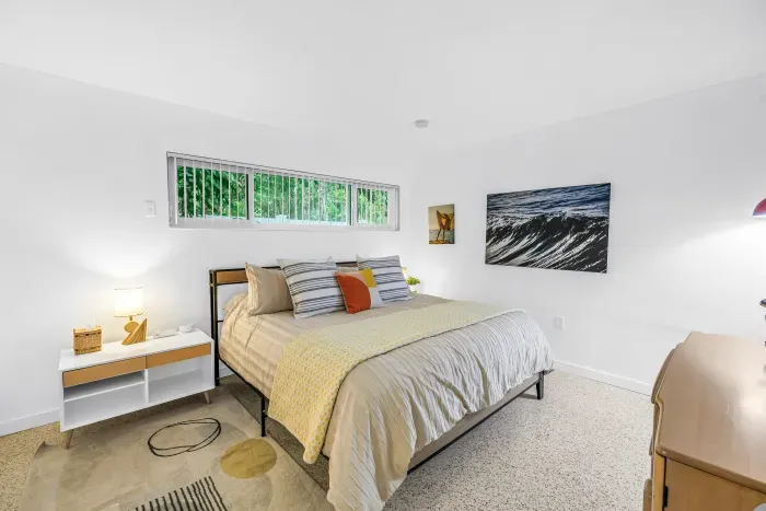 Bright, airy bedroom with cozy queen bed and clean modern style