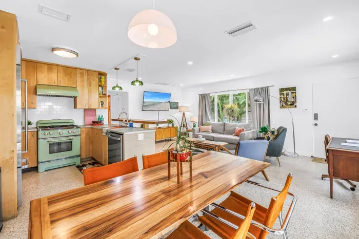 Bright open living space with retro kitchen and inviting lounge seating